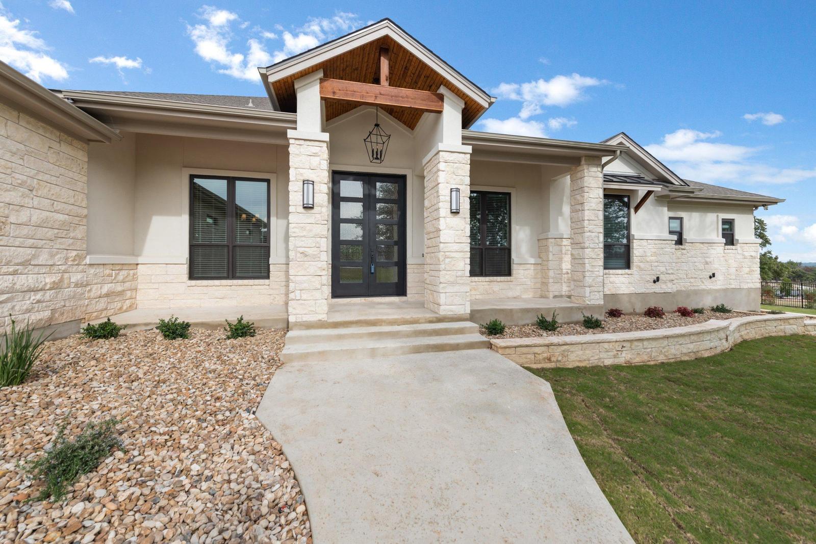 Stone and stucco custom home exterior built by Chance Leigh Custom Homes in Georgetown, Texas